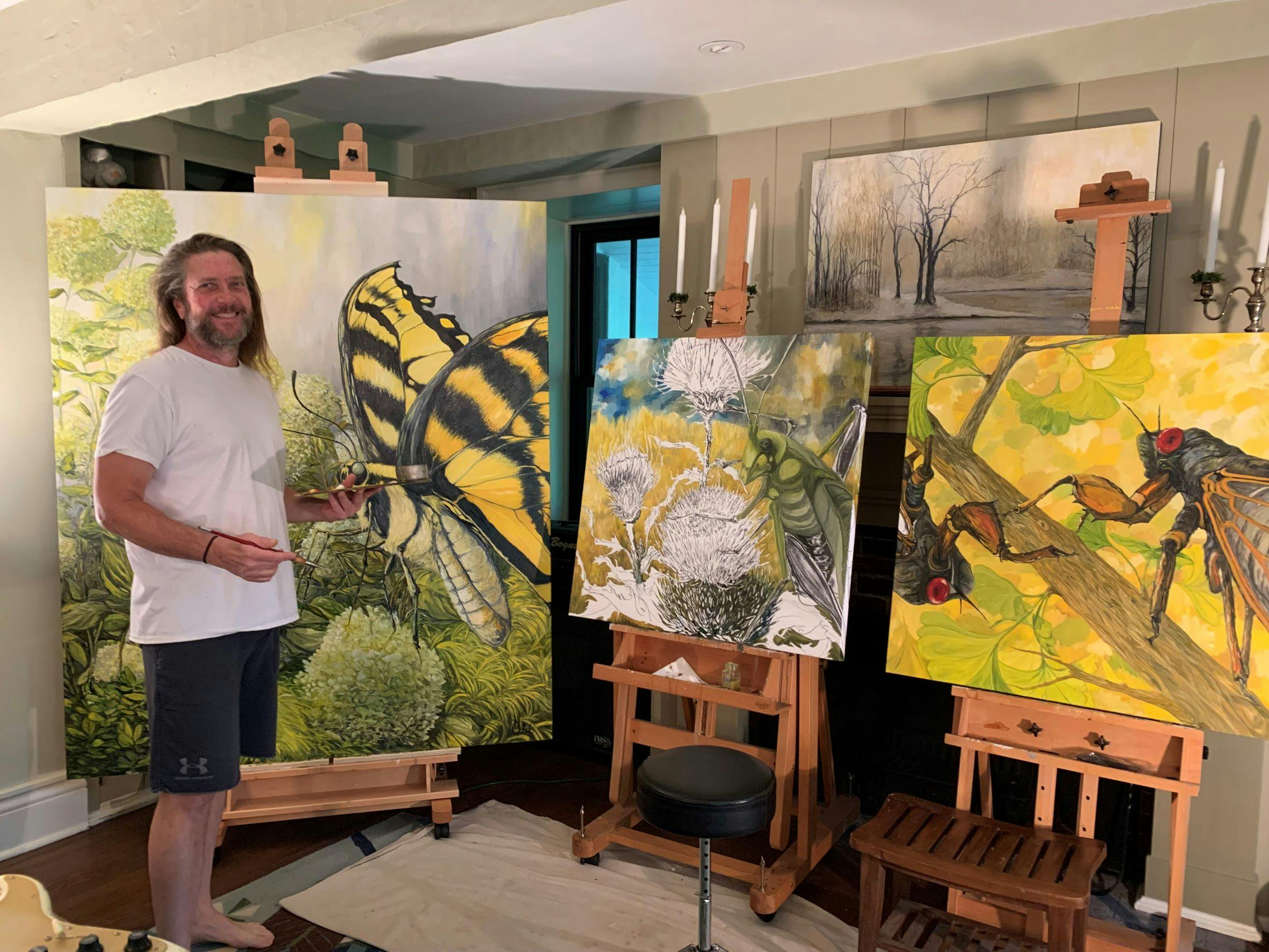 John Carman painting three new pieces of artwork in his studio.